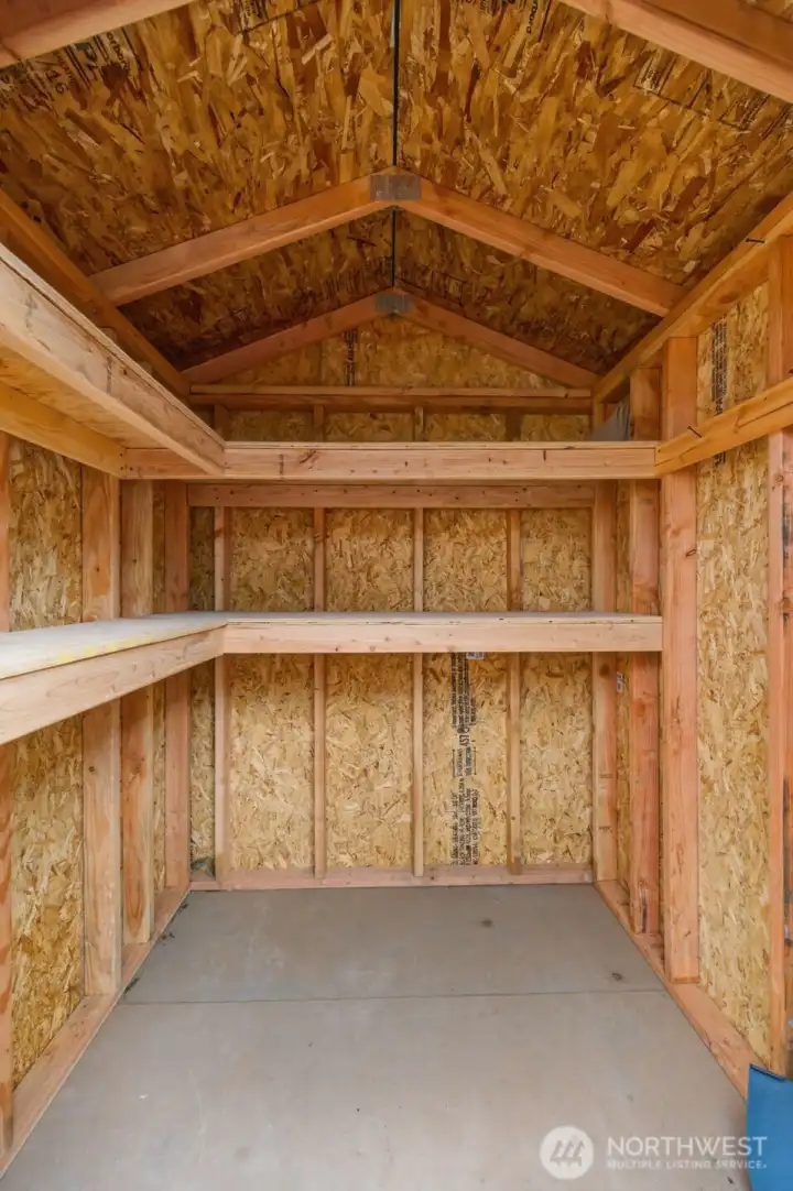 Interior of shed includes sturdy shelving—perfect for tools, gardening supplies, or seasonal décor.