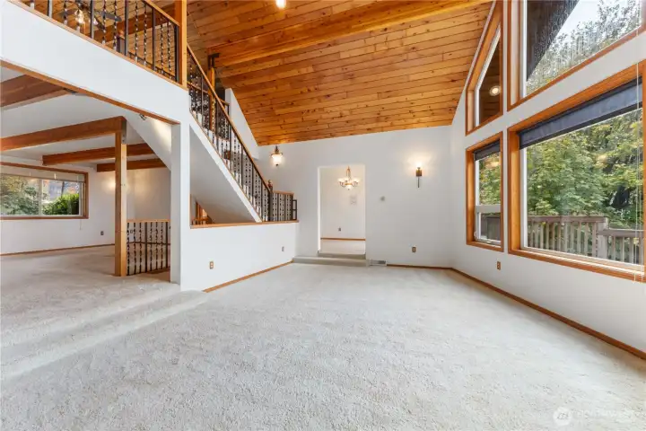 Living room has a open ceiling to the loft two steps up to the family room which is off of the kitchen