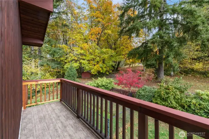 Upper loft has a new deck with views of the fantastic mature landscaping. Center left of photo shows shed and RV pad area. it is privately nestled in the landscape.