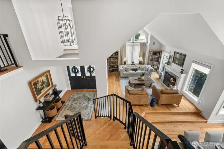 Overlooking the formal living and dining room; New wrought iron railings perfectly pair with the oak hardwood stairs.