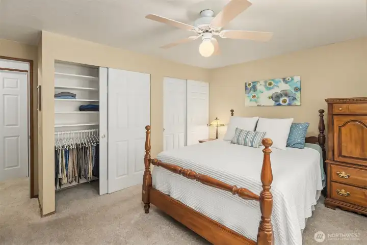 Primary bedroom closets both have built-in organizers.