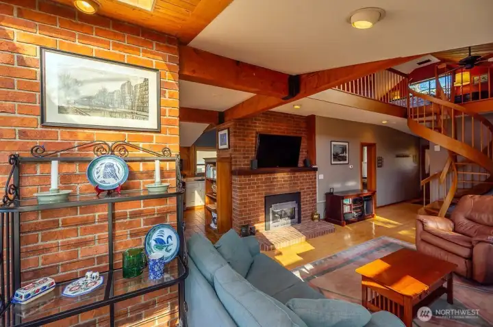 Main house living area with gas insert fireplace, seen from dining area