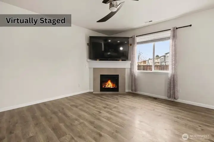 Living room with fireplace. Photo has been edited to remove furniture.