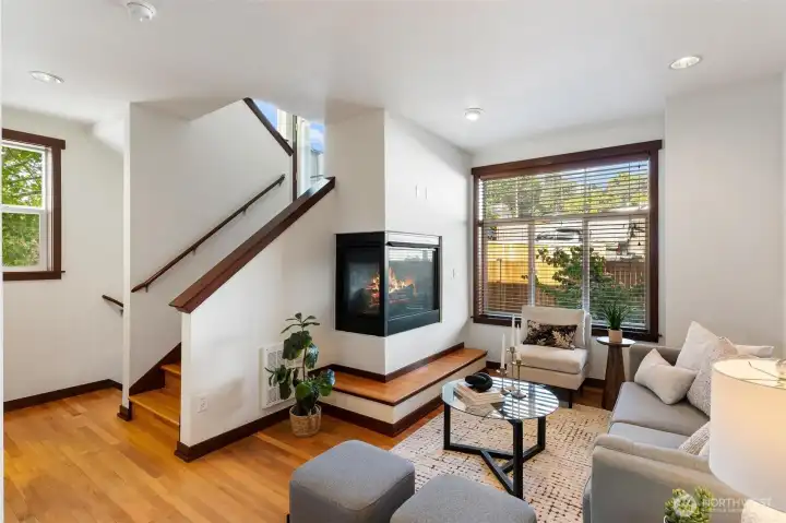 Alternate view of the open living room showcasing fireplace and flexible gathering space.