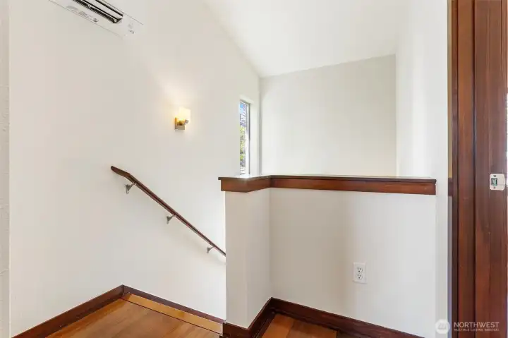 Stairway detail with warm wood finishes and efficient vertical layout.