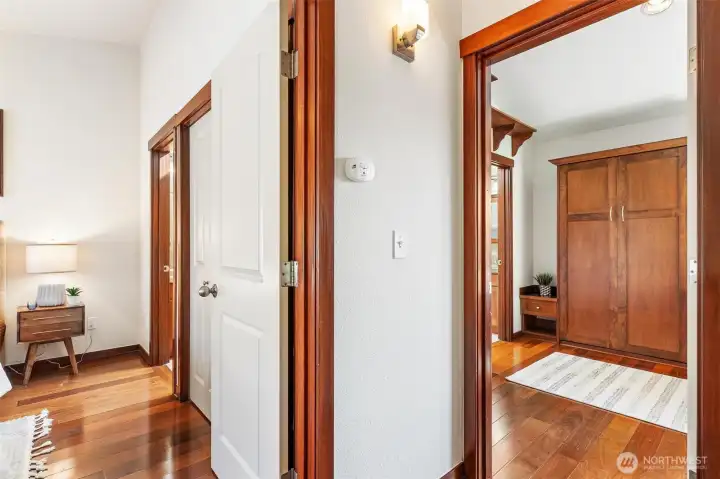 Hallway connecting private bedroom and bath areas.
