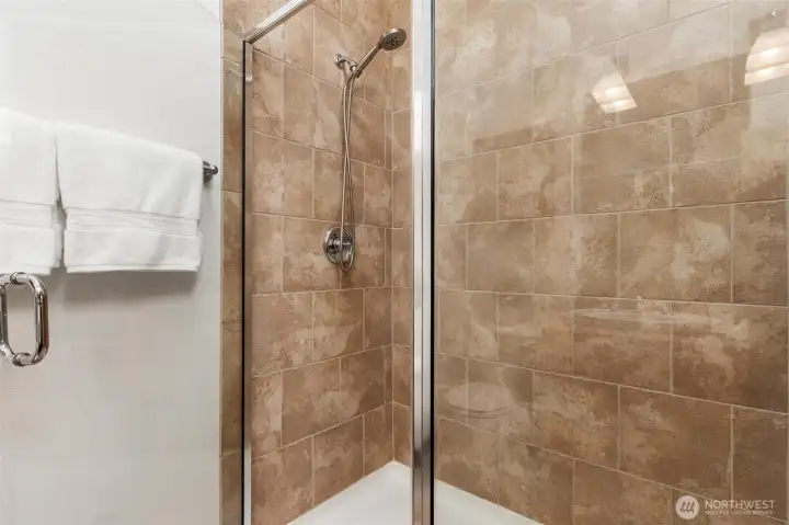 Walk-in shower with modern tile surround.