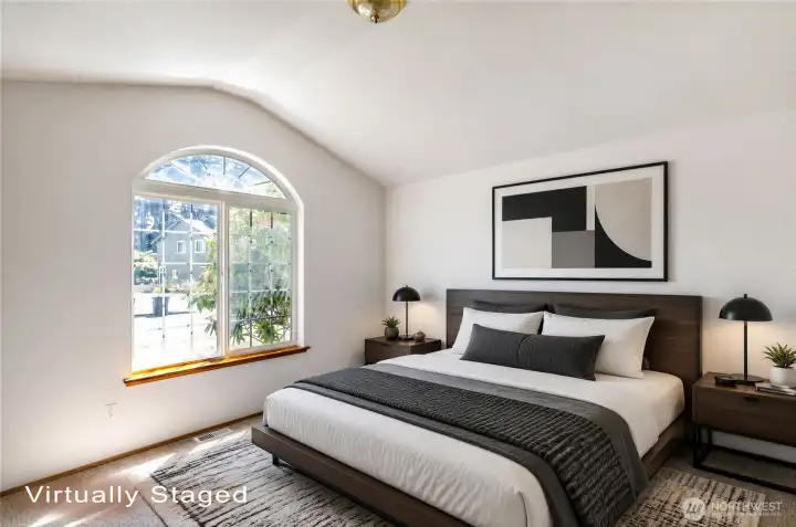 Primary bedroom has vaulted ceilings and decorative arched window. Primary bedroom has vaulted ceilings and decorative arched window.