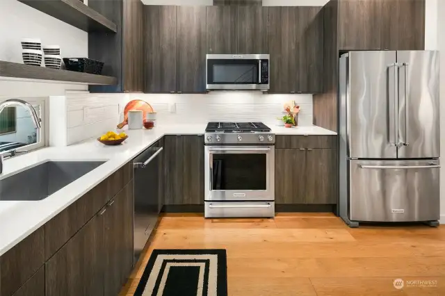 Bright kitchen with abundance of cabinets and quartz countertops.