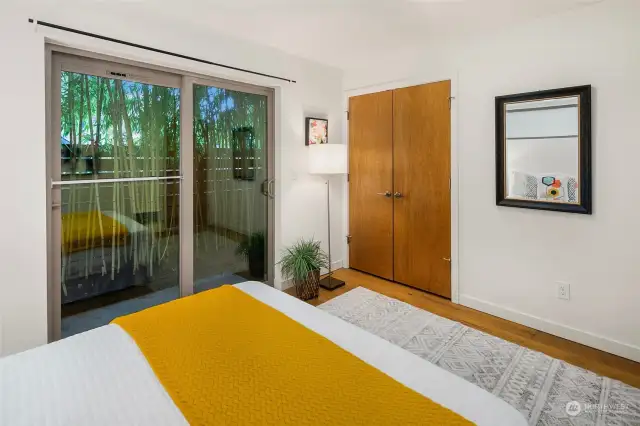 Entry level bedroom with sliding doors to patio.