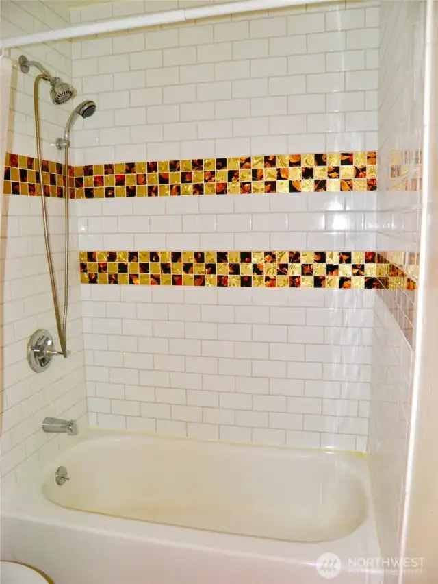 More beautiful tile work in the bathtob/shower area.