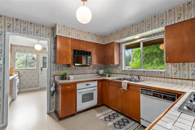 Mudroom/ laundry is adjacent to kitchen with access to generous yard