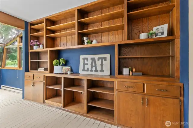 Custom shelves in the solarium just add to the elegance