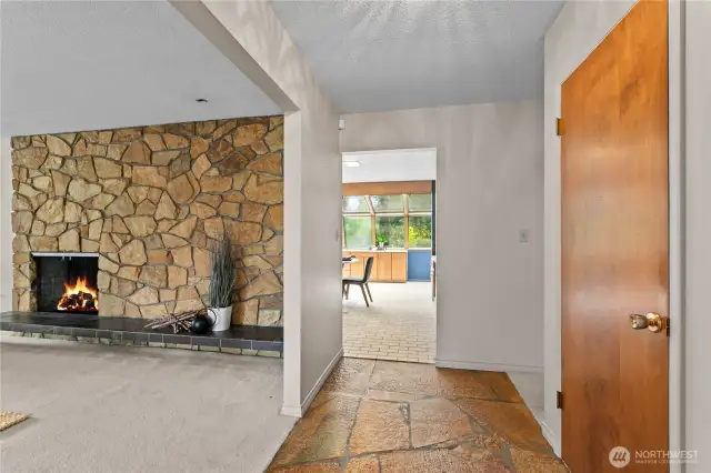 Entry opens to living room on left with real wood fireplace and solarium/sunroom directly ahead
