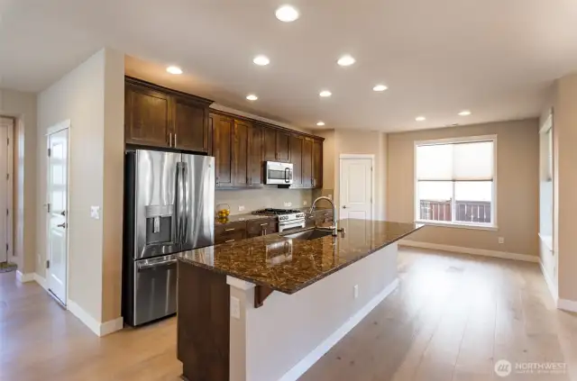 Look at this amazing open concept kitchen.  Everything you could want.  High end upgraded stainless appliances, loads of storage and massive entertainment island.