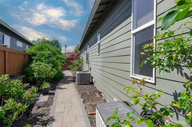 The side yard has many lovely plantings.  The lot size is larger than most.