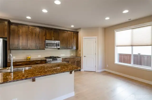 Another vie of the kitchen showing corner pantry and  breakfast nook.