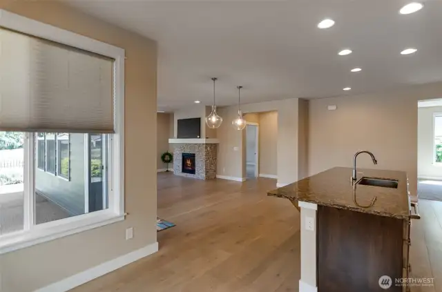 View from the nook.  Engineered hardwood floors through main living areas.  Beautiful quartz counter tops.  Great room ahead.