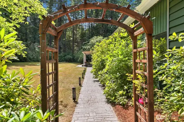 ARCHED WALKWAY TO COVERED PATIO & DECK