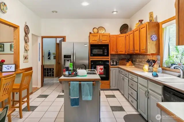 ANOTHER VIEW OF THE KITCHEN SHOWING THE ISLAND & BREAKFAST BAR