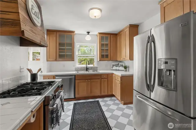 Kitchen is a blend of of classic farmhouse and modern with original light fixtures and upgraded SS appliances.