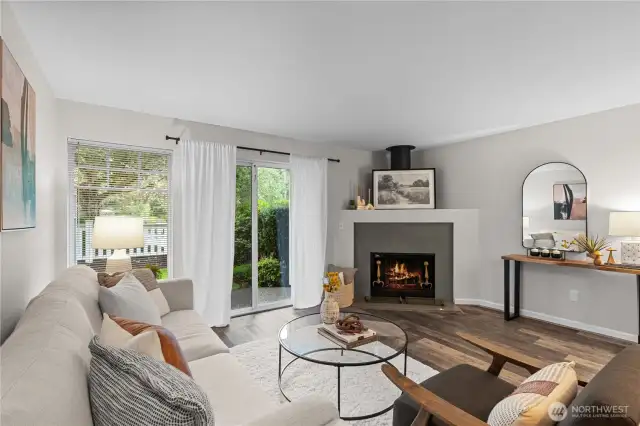 Gorgeous living room with wood burnig fireplace and a patio and small yard.  Even a hidden storage closet on the patio