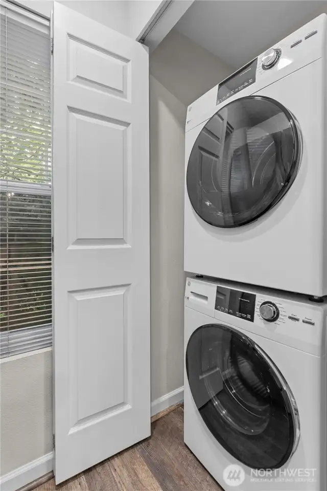 Laundry is hidden behind this door in the kitchen