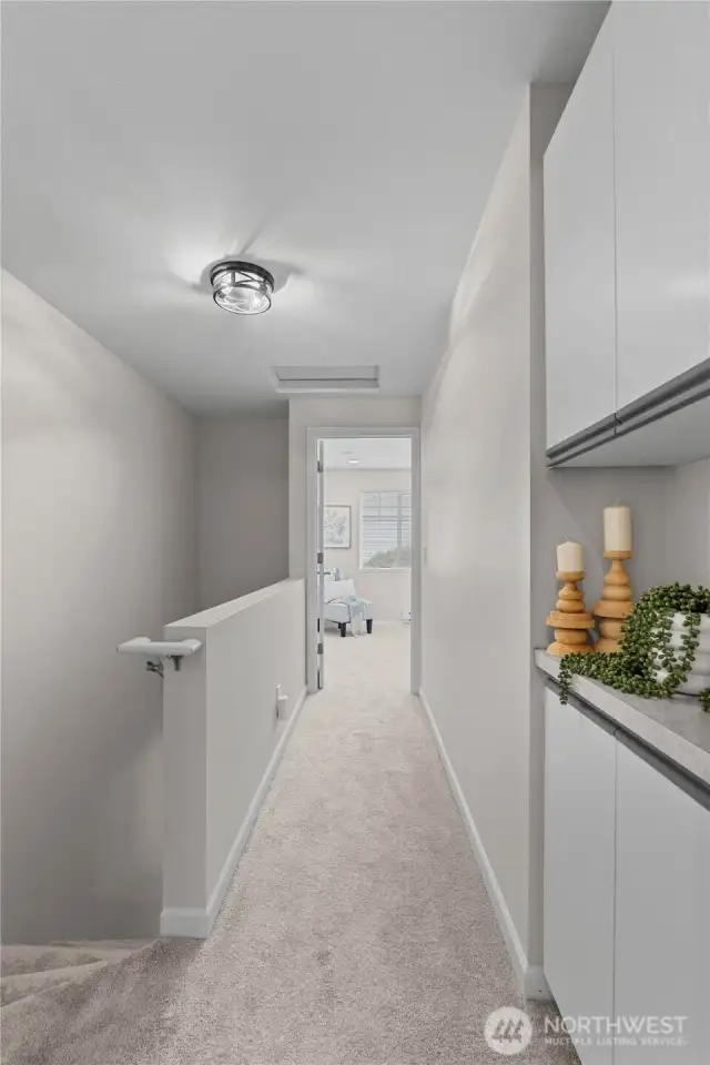 Upstairs hallway divides the two primary suites