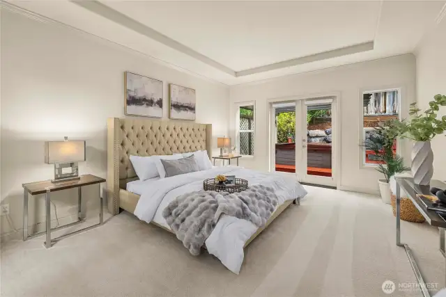 Spacious primary with door to yard and hot tub.