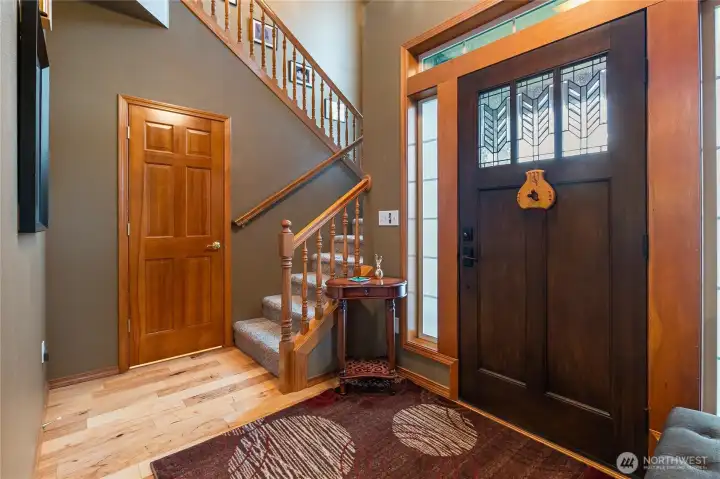 Welcoming entry featuring a generously sized closet with abundant storage that extends to the right and wraps around the base of the staircase—plenty of room for everything you need!