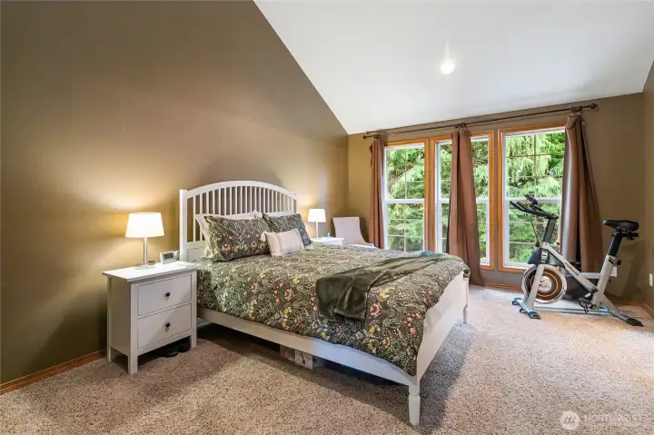 The upstairs primary ensuite features vaulted ceilings, enhancing the sense of space and openness.