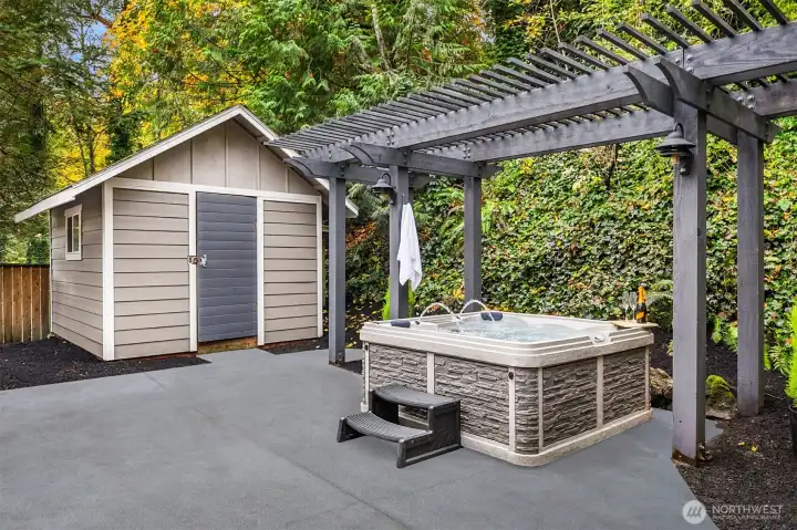 Hot tub and shed in backyard.