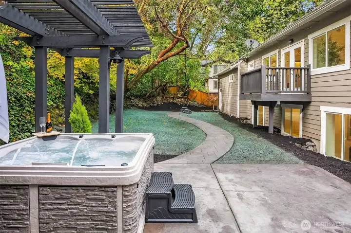 hydroseed on will sprout in 3-5 weeks. Hot tub showing fully fenced backyard and private balcony off main floor primary.