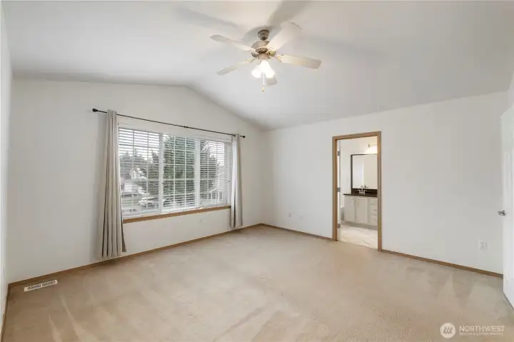 Primary Bedroom with vaulted ceilings.