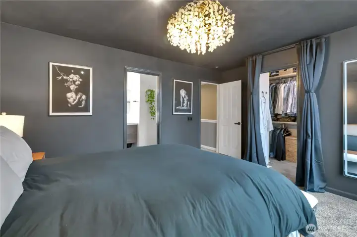Primary bedroom features a private bath and walk-in closet with custom closet system.