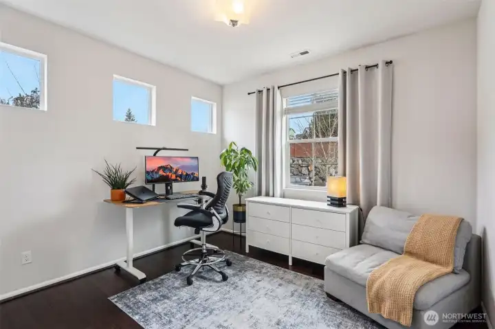 Main level bedroom that is currently being utilized as a functional and dedicated home office space.