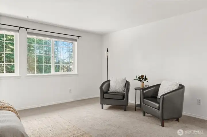Large sitting area in bedroom, with hidden wires and outlet to mount a TV