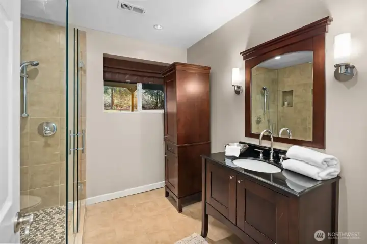 A ¾ bath located near the downstairs bedroom creates the perfect setup for an ideal guest suite, offering comfort, privacy, and convenience for visitors or multi-generational living.
