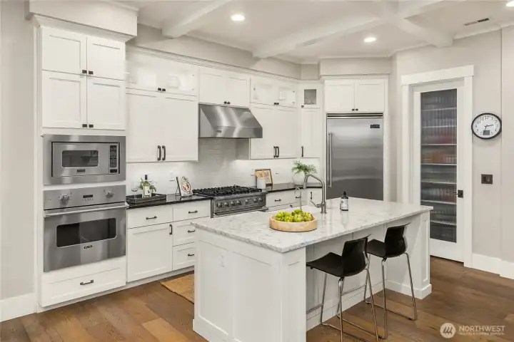 Chefs kitchen features premium stainless-steel appliances and walk-in pantry.