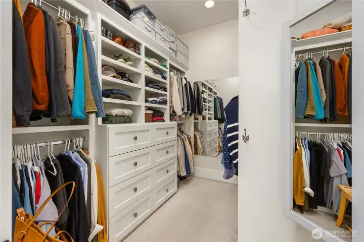 Primary with a large custom walk in closet.