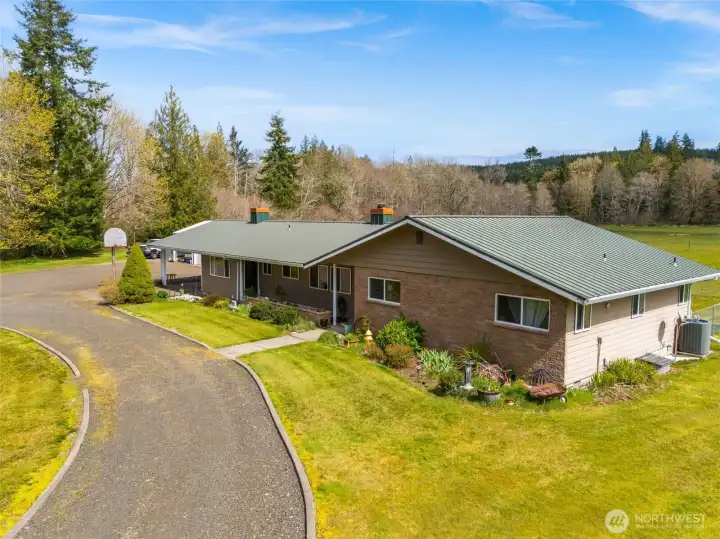 Classic single-story home set against a scenic backdrop.