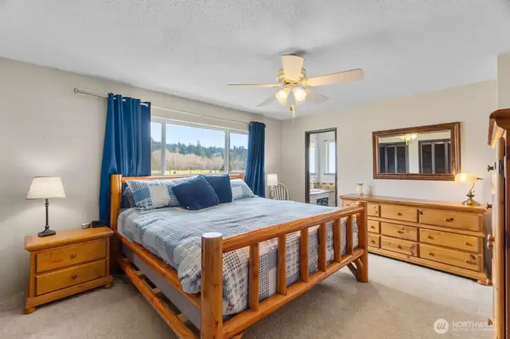 The primary bedroom is a peaceful setting designed for rest and relaxation.