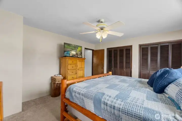Comfortable primary bedroom with dual closets.