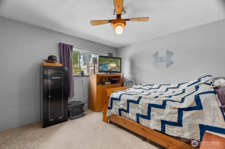 Additional bedroom with a ceiling fan for added comfort.