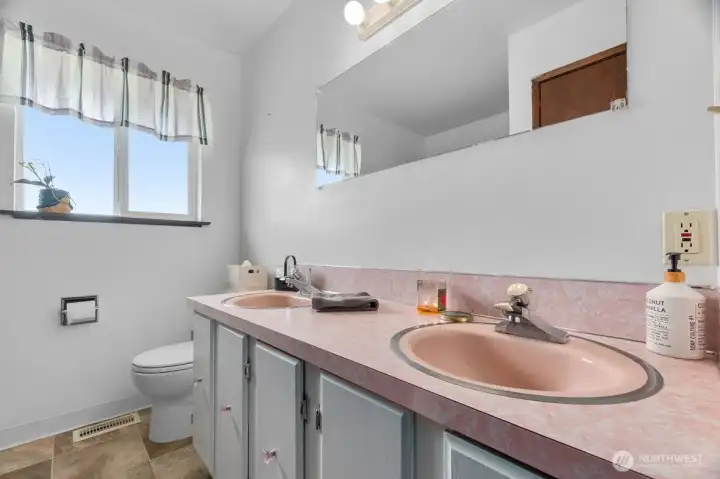 Full bathroom with dual sink vanity.
