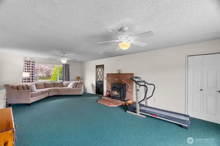 Spacious family room with brick surround fireplace.