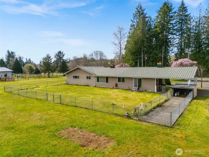 Partially fenced yard offering flexibility and function. Dedicated dog run for pets to roam safely.
