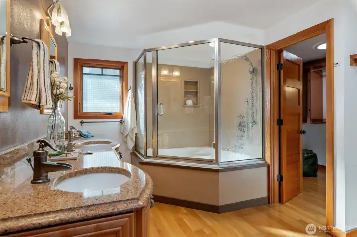 Jetted soaking tub with shower.