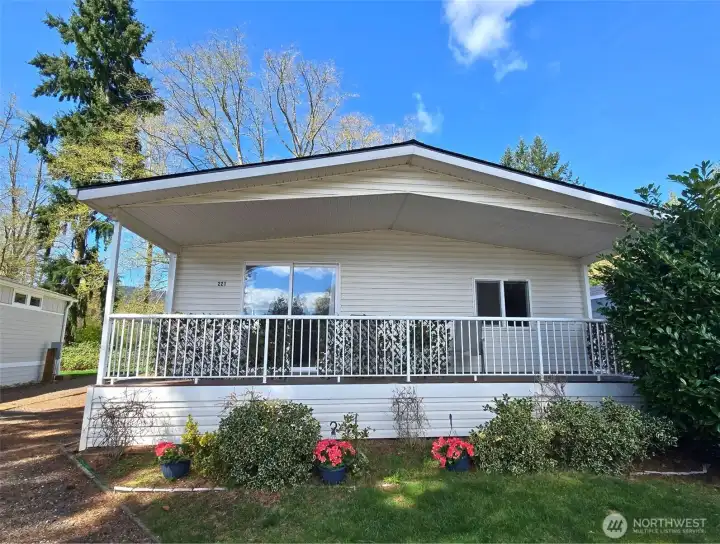 Welcoming front entry to this single-level  manufactured home near Lake Samish,  offering low-maintenance living in a  peaceful 55+ community