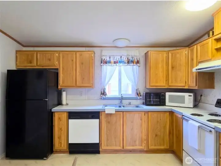 Functional kitchen with ample cabinetry and  counter space designed for everyday living